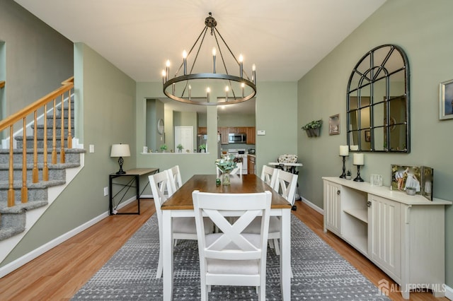 274 Pinelli Dr, Piscataway, NJ 08854 - dining area featuring wood finished floors, a chandelier, and stairs