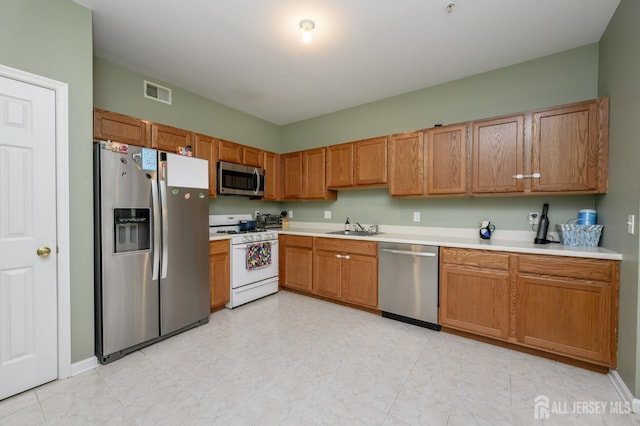274 Pinelli Dr, Piscataway, NJ 08854 - kitchen with appliances with stainless steel finishes, light countertops, and brown cabinetry