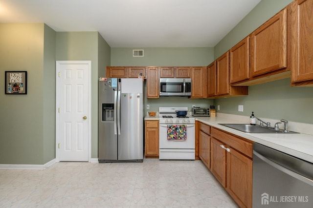 274 Pinelli Dr, Piscataway, NJ 08854 - kitchen featuring appliances with stainless steel finishes, light countertops, and brown cabinets