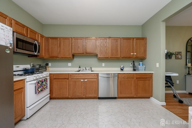 274 Pinelli Dr, Piscataway, NJ 08854 - kitchen with stainless steel appliances, light countertops, brown cabinets, and light marble finish flooring