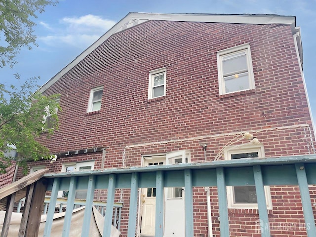 170 Rutgers St, New Brunswick, NJ 08901 - view of side of property with brick siding and a balcony