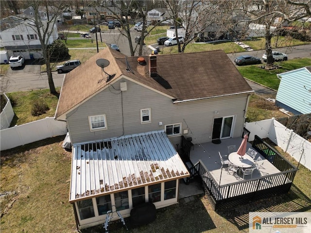 182 Columbia Ave, North Plainfield, NJ 07060 - back of house featuring a fenced backyard, a deck, a chimney, roof with shingles, and a residential view
