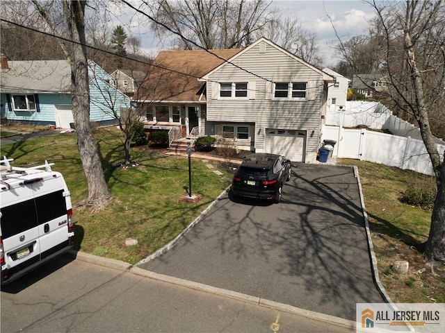 182 Columbia Ave, North Plainfield, NJ 07060 - tri-level home featuring asphalt driveway, a garage, and a gate