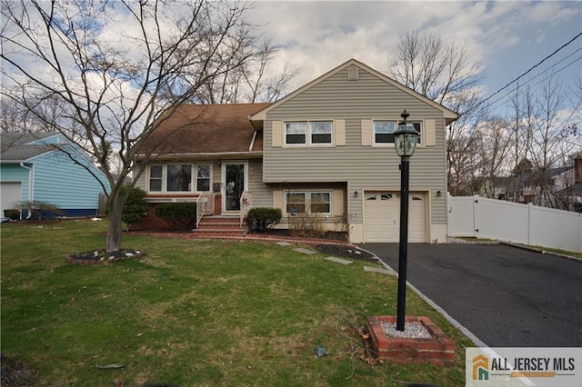 182 Columbia Ave, North Plainfield, NJ 07060 - split level home with an attached garage and asphalt driveway