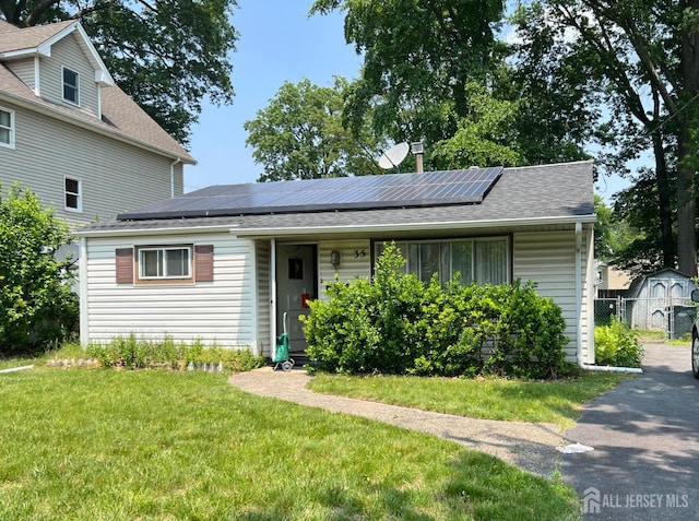 35 Orchard St, Metuchen, NJ 08840 - view of front of home featuring a front lawn, roof mounted solar panels, and roof with shingles