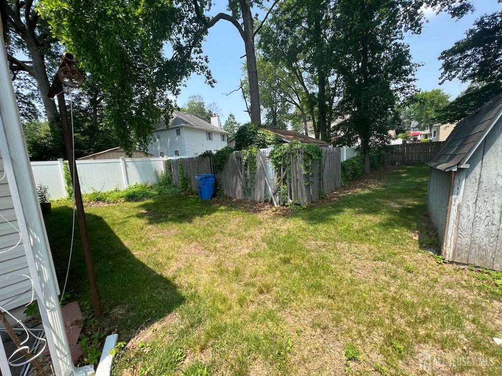 35 Orchard St, Metuchen, NJ 08840 - fenced backyard featuring a storage unit
