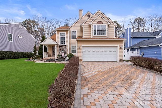 front of property with a garage and a front lawn