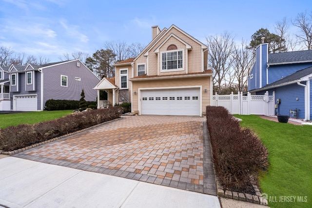 view of property with a garage and a front yard