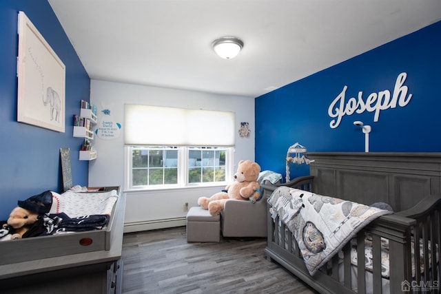 bedroom featuring a baseboard radiator and wood-type flooring