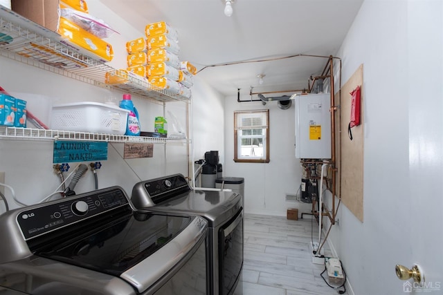 laundry room with washer and clothes dryer, water heater, and light hardwood / wood-style floors