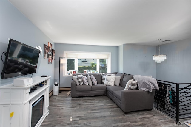 living room featuring an inviting chandelier and dark hardwood / wood-style flooring