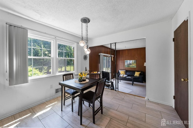 85 Hidden Lake Dr, North Brunswick, NJ 08902 - dining area with wooden walls and a textured ceiling