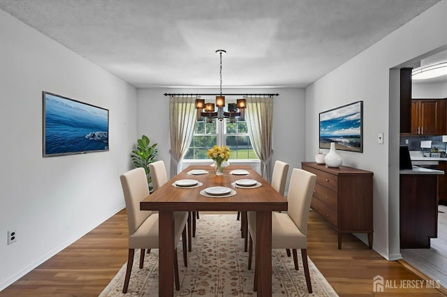 85 Hidden Lake Dr, North Brunswick, NJ 08902 - dining area with a chandelier and light wood-style flooring