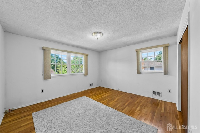 85 Hidden Lake Dr, North Brunswick, NJ 08902 - spare room with wood finished floors and a textured ceiling