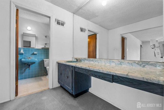 85 Hidden Lake Dr, North Brunswick, NJ 08902 - bathroom with a textured ceiling and tile walls