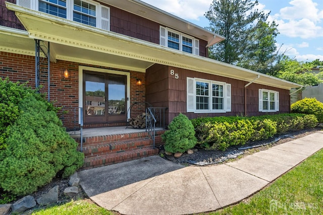 85 Hidden Lake Dr, North Brunswick, NJ 08902 - doorway to property featuring covered porch and brick siding