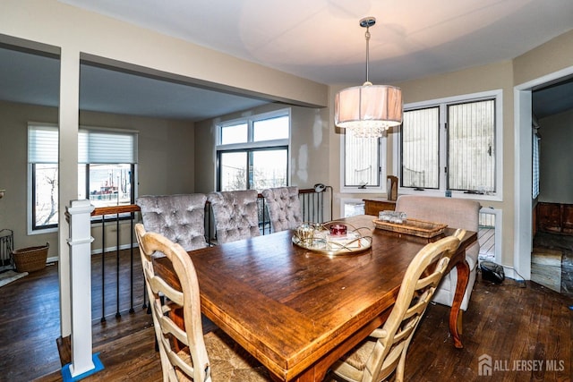 dining area featuring baseboards, dark wood-style flooring, and ornate columns