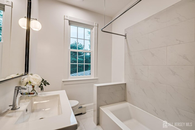 full bathroom with a sink, toilet, marble finish floors, shower / bathtub combination, and a baseboard heating unit