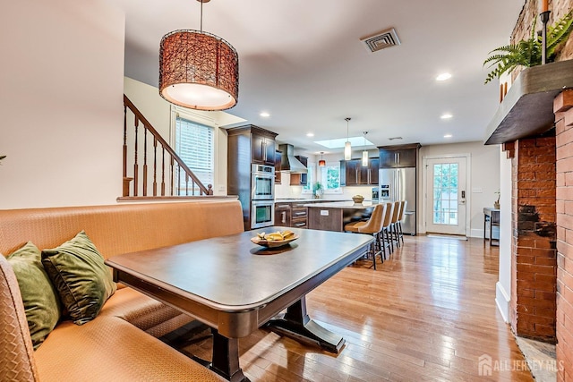 dining area featuring stairs, light wood-style floors, recessed lighting, and baseboards