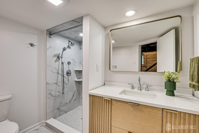 full bathroom featuring marble finish flooring, toilet, a marble finish shower, and vanity