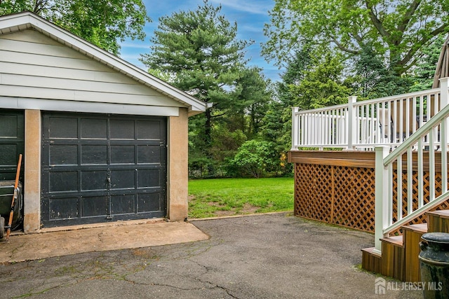 detached garage with asphalt driveway