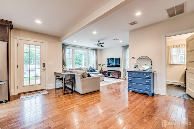 living area with a baseboard radiator, light wood-type flooring, healthy amount of natural light, ceiling fan, and recessed lighting