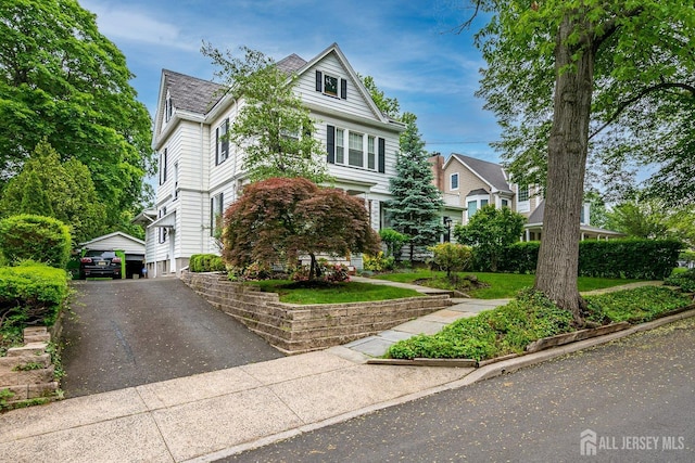 view of front of property with an outdoor structure and a garage