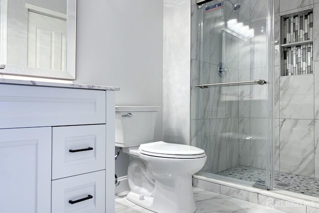 full bath with marble finish floor, a shower stall, toilet, and vanity