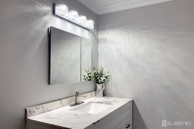 bathroom with ornamental molding and vanity