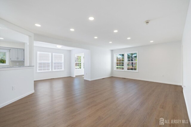 unfurnished living room featuring dark hardwood / wood-style floors