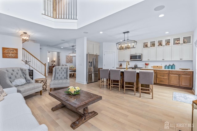 85 Valentino Dr, Old Bridge, NJ 08875 - living room with a chandelier, stairway, light wood-style floors, and recessed lighting