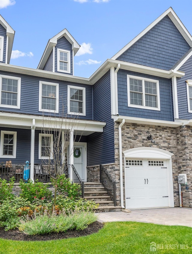 85 Valentino Dr, Old Bridge, NJ 08875 - view of front of home with an attached garage, stone siding, and a porch