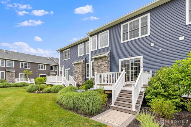 85 Valentino Dr, Old Bridge, NJ 08875 - rear view of house with a wooden deck, a yard, stairs, and stone siding