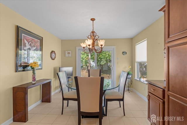 dining area with light tile patterned flooring and a chandelier