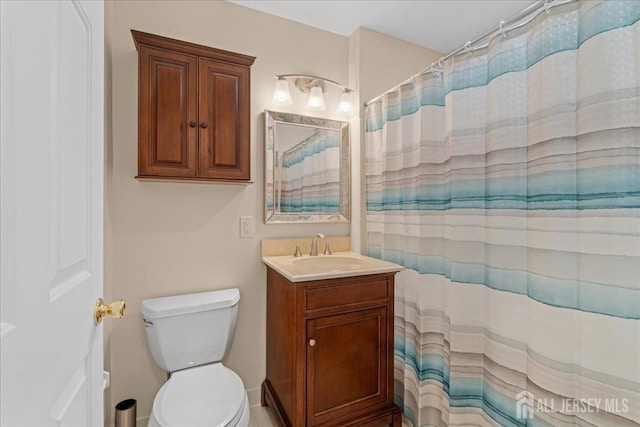 bathroom with vanity, toilet, and curtained shower