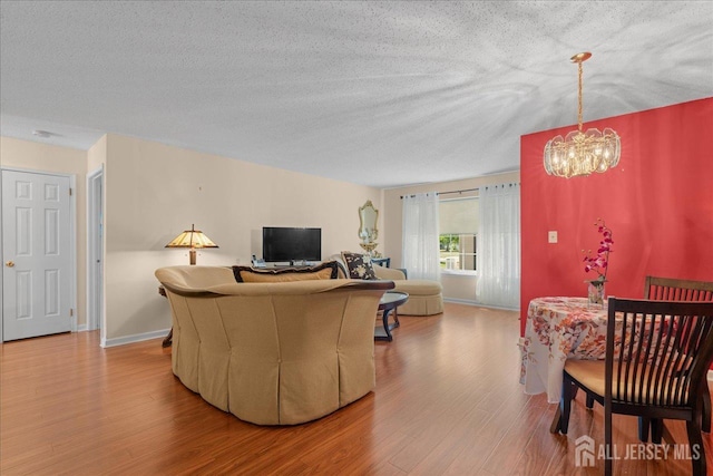 living room with hardwood / wood-style flooring and an inviting chandelier