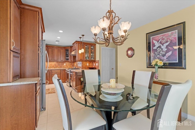 dining space with light tile patterned floors and a notable chandelier