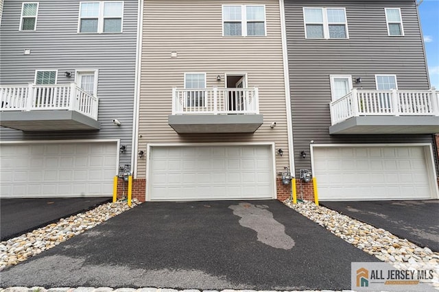 1604 English Ln, Sayreville, NJ 08859 - back of house featuring an attached garage, driveway, and brick siding