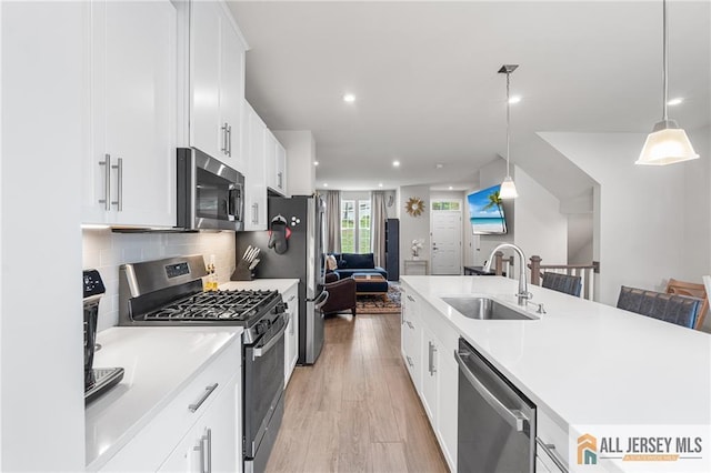 1604 English Ln, Sayreville, NJ 08859 - kitchen with stainless steel appliances, open floor plan, white cabinetry, light countertops, and recessed lighting