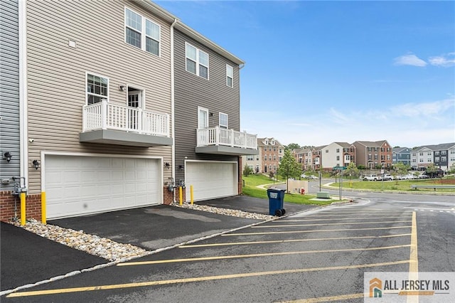 1604 English Ln, Sayreville, NJ 08859 - rear view of house featuring a residential view, driveway, brick siding, and an attached garage