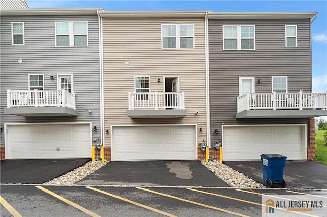 1604 English Ln, Sayreville, NJ 08859 - back of house featuring brick siding, asphalt driveway, and an attached garage