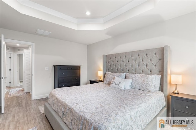 1604 English Ln, Sayreville, NJ 08859 - bedroom with wood finished floors, a tray ceiling, and recessed lighting