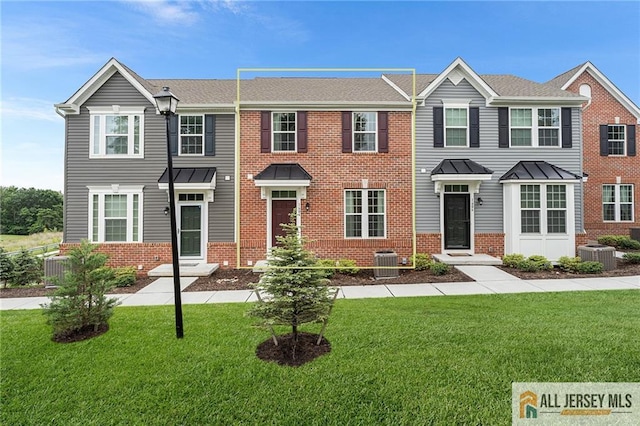1604 English Ln, Sayreville, NJ 08859 - view of property with brick siding and a front yard