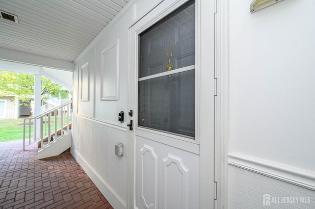 doorway to property featuring a porch