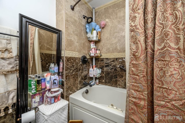 bathroom featuring tile walls and tiled shower / bath combo