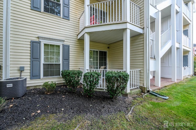 property entrance with central air condition unit and a balcony