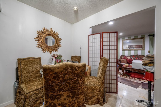 sitting room with light tile patterned floors and a textured ceiling