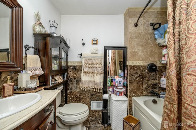 full bathroom featuring shower / bath combo with shower curtain, vanity, tile walls, and toilet