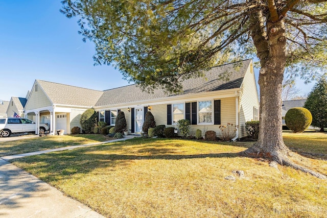 view of front of property with a garage and a front yard