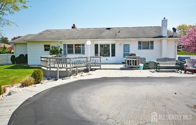 107 N Edward St, Sayreville, NJ 08872 - rear view of house with a chimney and a wooden deck